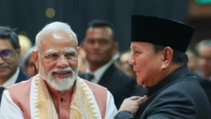 Prime Minister Narendra Modi and Indonesian President Prabowo Subianto share a light-hearted conversation about the lucky number 8 during the Indian diaspora event in Jakarta, highlighting the growing friendship between India and Indonesia.